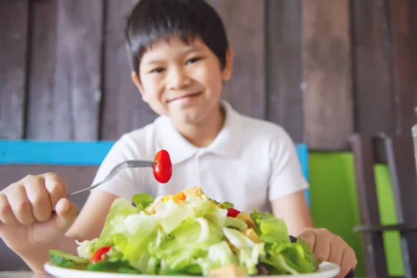 Boy happy ready to eat vegetable salad - people with clean fresh healthy food concept