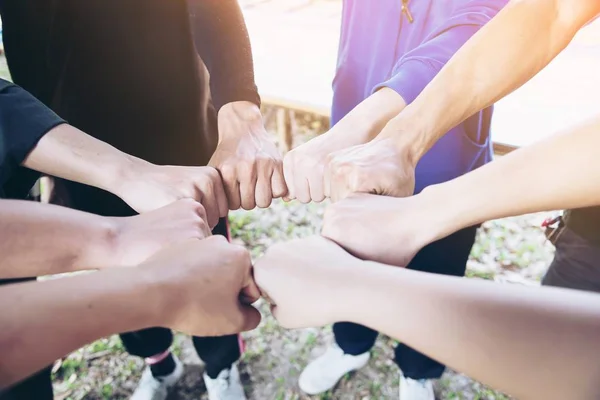 People join hand together during their work - human commitment concept