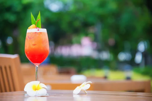 Cocktail recipe name mai tai or mai thai worldwide favour cocktail include rum lime juice orgeat syrup and orange liqueur - sweet alcohol drink with flower in garden relax vacation concept