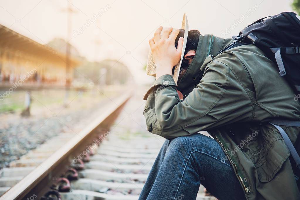 Travel man wait train at platform - people vacation lifestyle activities at train station transportation concept