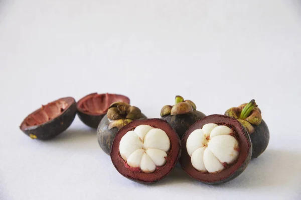 Mangosteen Thai popular fruits - a tropical fruit with sweet juicy white segments of flesh inside a thick reddish-brown rind.