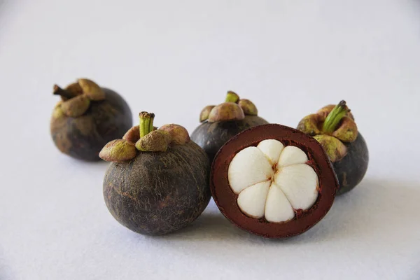 Mangosteen Thai popular fruits - a tropical fruit with sweet juicy white segments of flesh inside a thick reddish-brown rind.