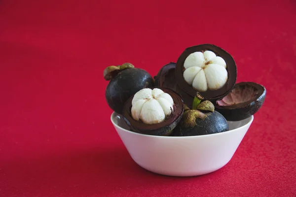 Mangosteen Thai popular fruits - a tropical fruit with sweet juicy white segments of flesh inside a thick reddish-brown rind.