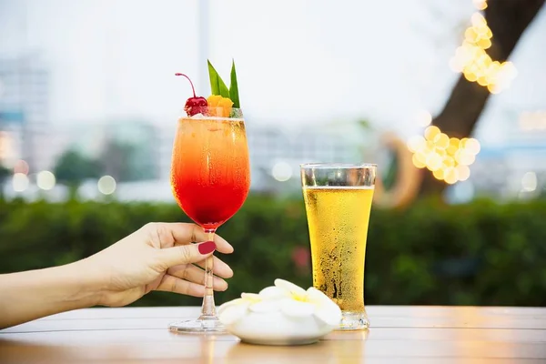 People celebration in restaurant with beer and mai tai or mai thai - happy lifestyle people with happy drink in garden concept