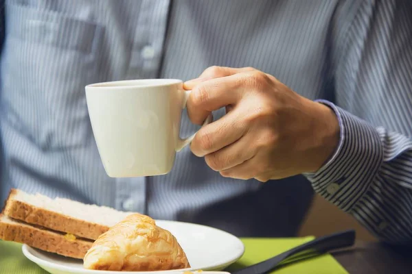Business man eat the American breakfast set in a hotel - people take a breakfast in hotel concept