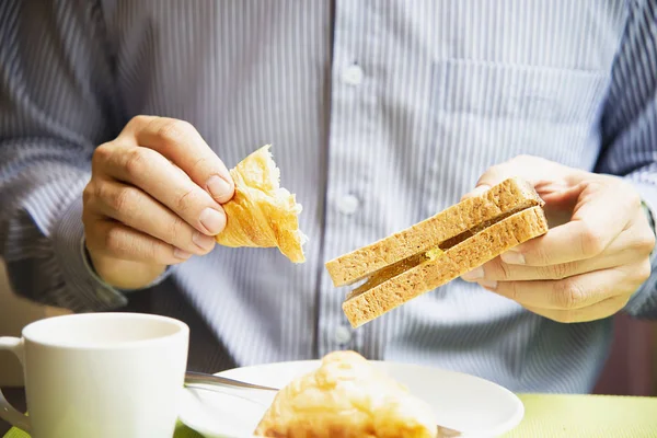 Business man eat the American breakfast set in a hotel - people take a breakfast in hotel concept