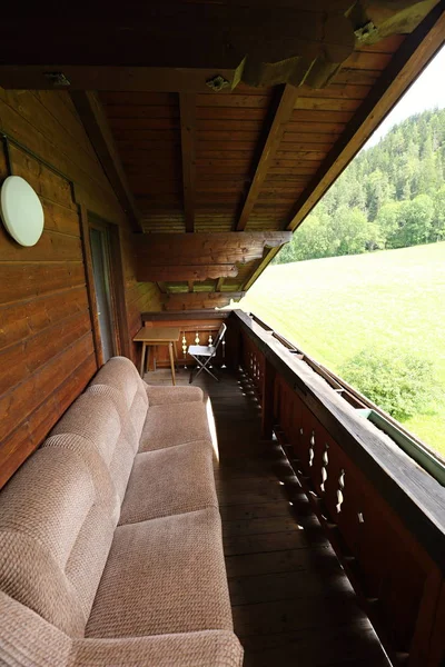 Old couch on the balcony of the chalet