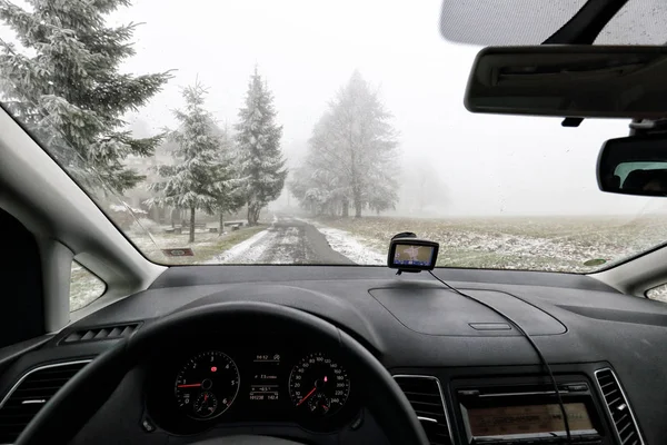 Панель приладів автомобіля на туманній сніговій покритій дорозі — стокове фото