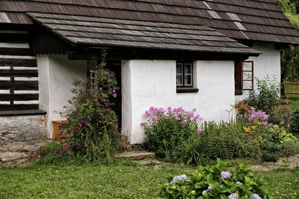 Veranda of the historic building with flower garden — Stock Photo, Image