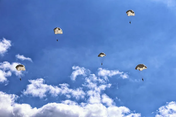 Vintage paratroopers on the cloudy sky — Stock Photo, Image