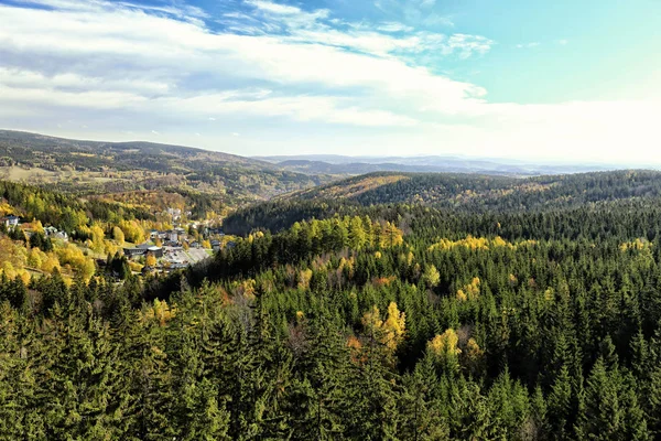 Forest zahrnuty kopcích Krkonoš s některé budovy — Stock fotografie