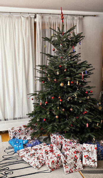 Christmas tree with plenty of presents in the living room