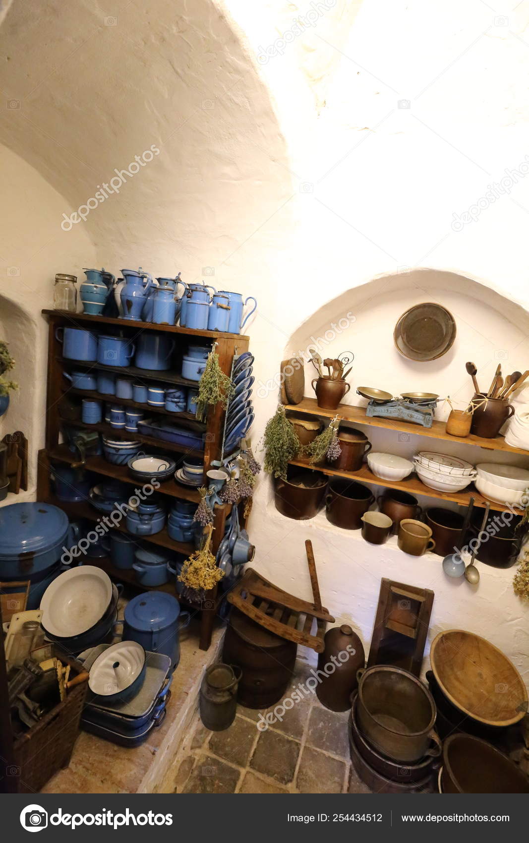 Small Storage Cabinet Full Of Enamelled Blue Dishes Stock Photo