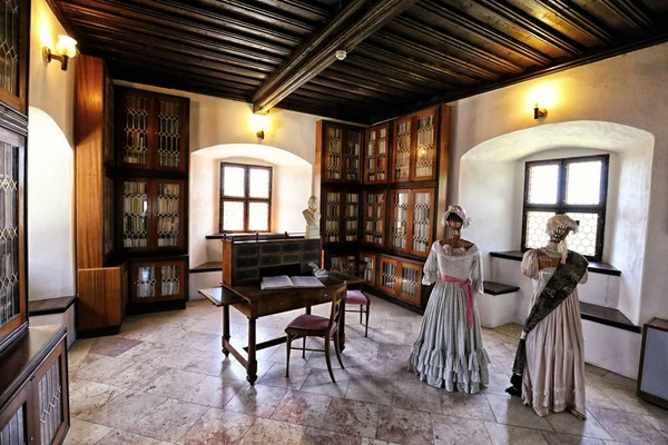 Interior of the castle library with two lady figures