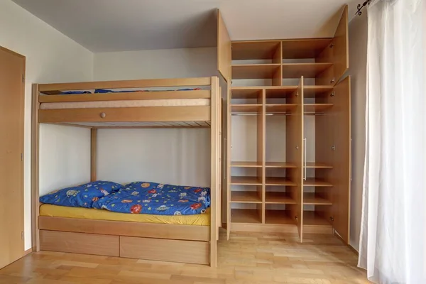 Children's bunk bed with large build-in wardrobe with open doors Royalty Free Stock Photos
