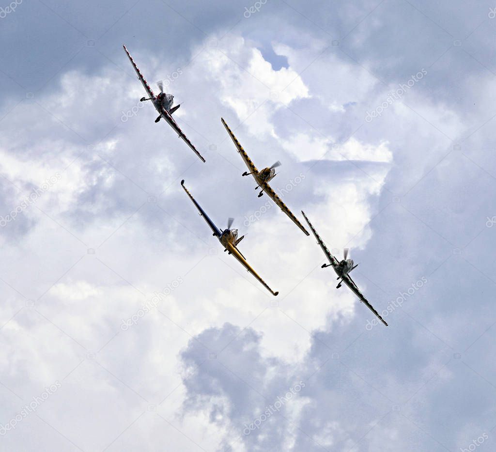 Front of four acrobatic planes on the cloudy sky