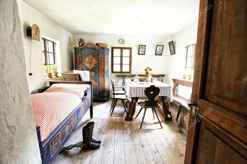 Small bedroom of the historic house with painted cabinet