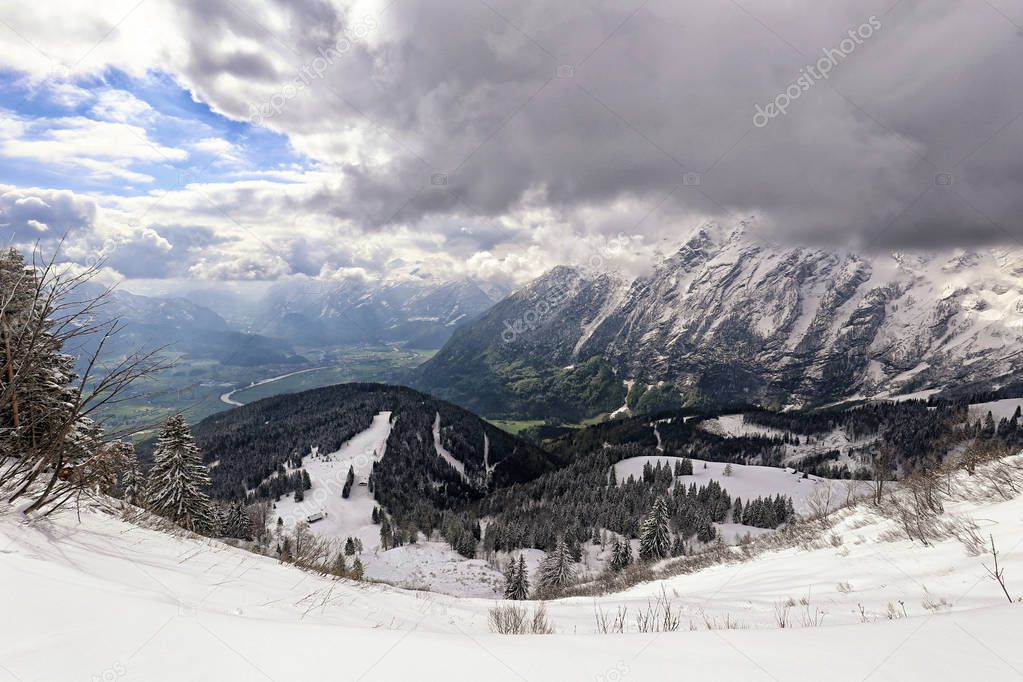Deep Alpine valley by Salzburg city under high mountains