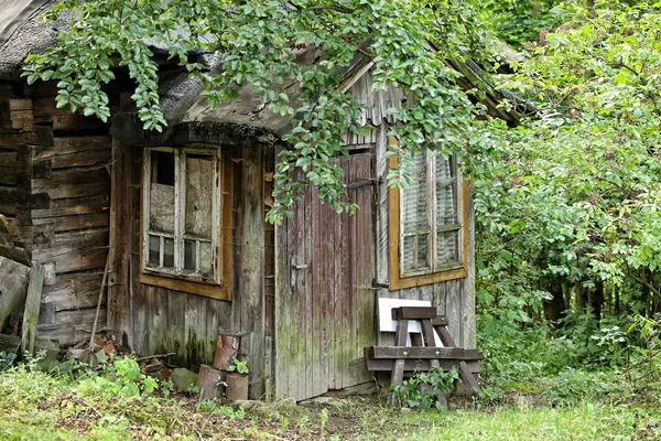 Old wooden cottage porch with broken windows — Stock Photo, Image