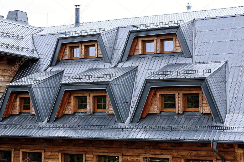 Gray tin roof on big timbered house