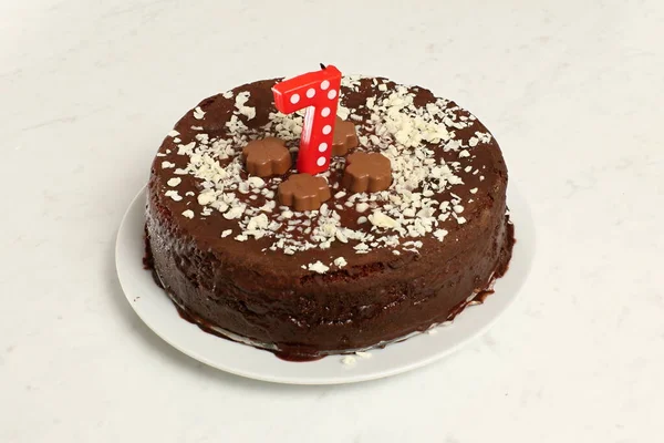 Child birthday chocolate cake with red number seven