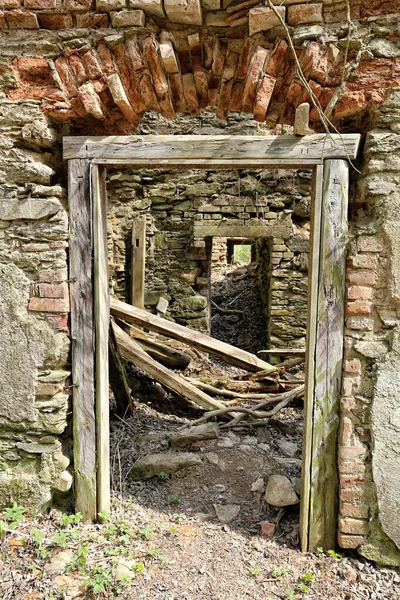 Old wooden door frame of abandoned ruined residental building