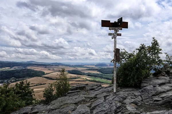 Metal pole on the top of Boren mountain near Bilina on cloudy summer day
