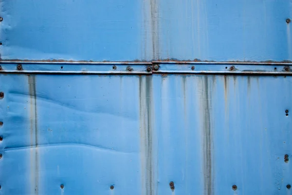 Wkręty na niebieskim Rusty tle — Zdjęcie stockowe