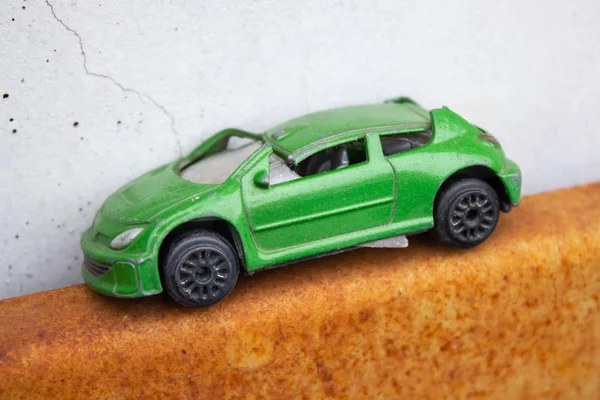 broken green toy car