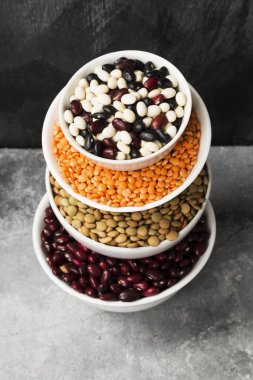 Fasulye ürün yelpazesine (kırmızı mercimek, yeşil mercimek, nohut, bezelye, Kuru fasulye, fasulye, mix fasulye, mung fasulye) gri arka plan üzerinde