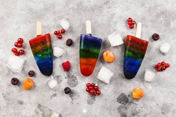 Rainbow ice cream popsicle on a gray background. Top view. Food background