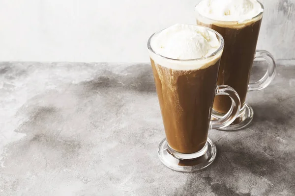 Ice coffee with ice cream on gray background. Copy space. Food b