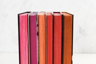 Beyaz arkaplanda renk yığını olan kitap yığını