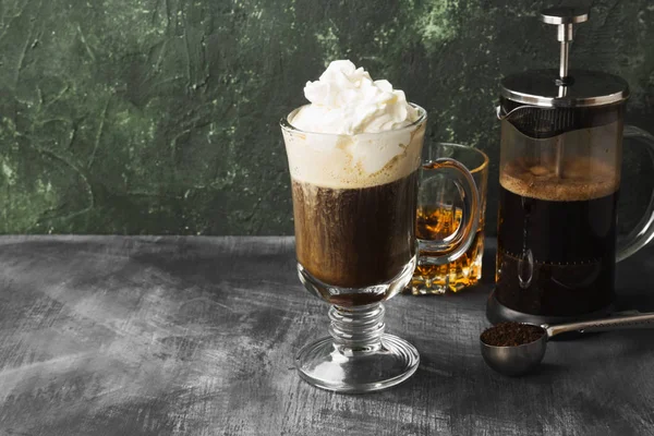 Irish coffee with whisky on dark background. Copy space. Food ba