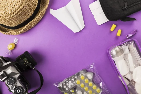 Set for flight small bottles with cosmetics, camera, hat, paper