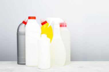 Çeşitli deterjanlar ve temizlik ürünleri ajansı, gri arka plan. Boşluğu kopyala