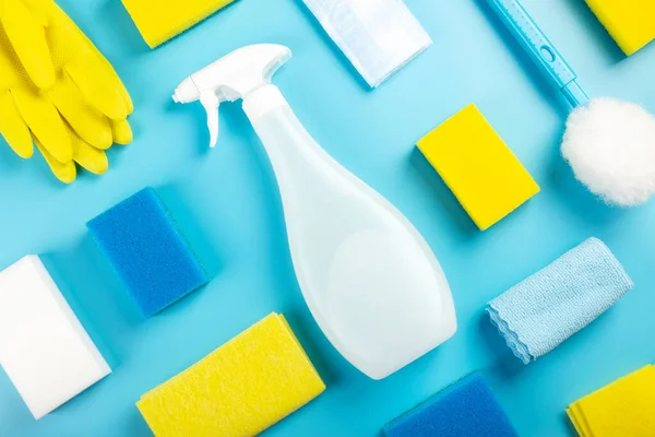 Detergents and cleaning product agent, sponges, napkins and rubber gloves, blue background. Top view