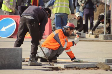 İşçiler kaldırıma döşeme döşedi