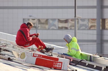 İşteki yüksek çatıdaki inşaatçılar