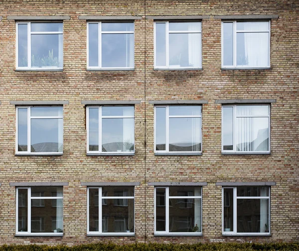 Wall of a residential block of flats with balconies windows