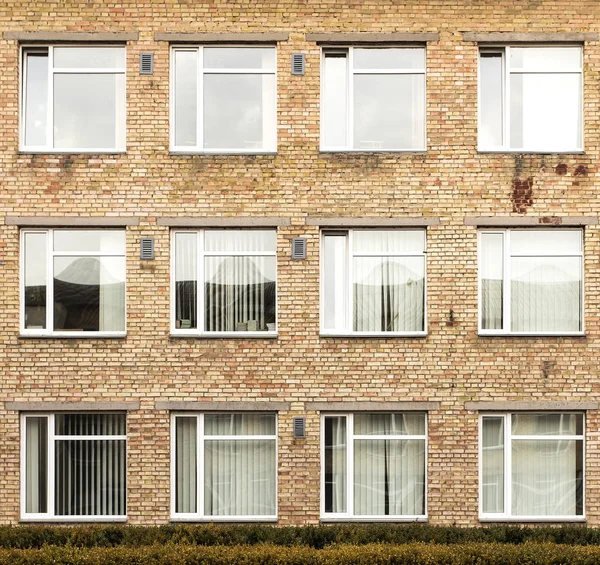 Wall of a residential block of flats with balconies windows