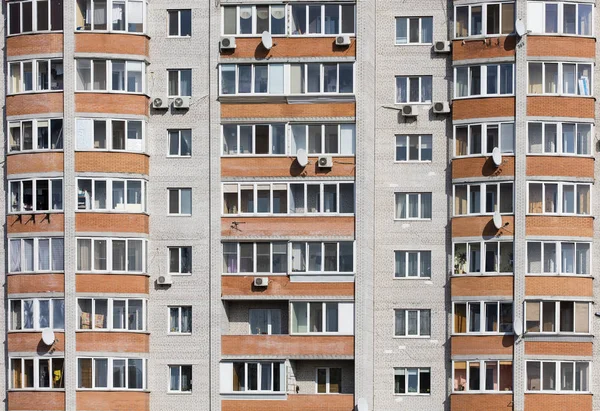 Wall of a residential block of flats with balconies windows