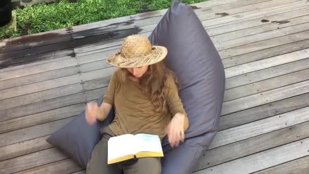 Attractive Woman Book Relaxing While Sitting Beanbag Chair Wooden Terrace — Stock Video