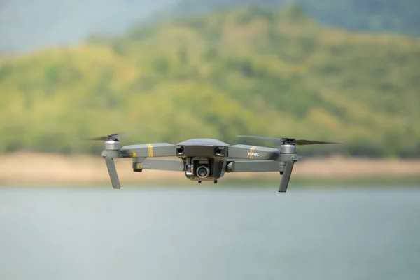 Drone or fly camera in flight. Royalty high quality stock photo of mavic drone or aerial quad copter with digital camera flying on a clear sunny sky