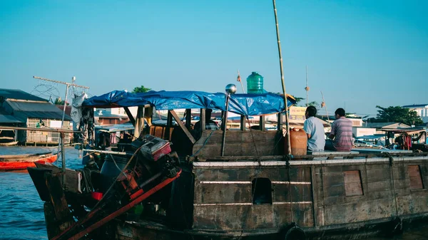 Tourists and people buy and sell food, vegetable, fruits on vessel, boat, ship in Cai Rang floating market at Mekong River. Royalty free stock image of the floating market or river market in Vietnam