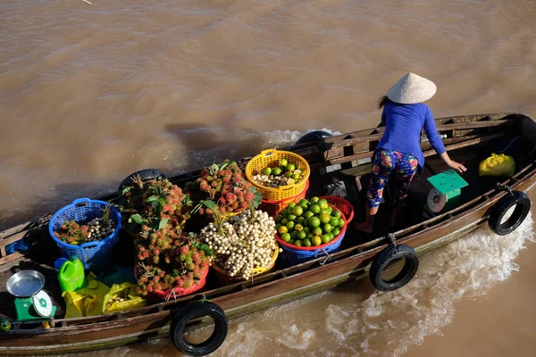 Vietnamese woman with conical hat buy and sell on vessel, boat, ship in Cai Rang floating market at Mekong River. Royalty free stock image of the floating market or river market in Can Tho, Vietnam