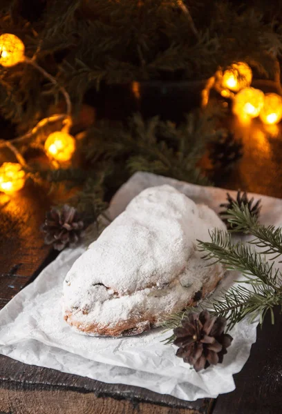 Dresden Stollen is a Traditional German Cake with raisins on a light knitted background.Gift for Christmas.Vintage style.Fruit cake for the Holiday