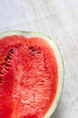 Yarım bir sulu karpuz ışık Beyaz ahşap zemin, clos üzerinde