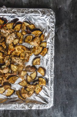 Koyu arka planda pişmiş tavuk ve patlıcan. Üst görünüm.