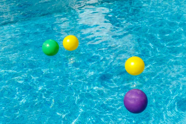 Inflatable water fun balls float on the water in the pool. Conce — Stock Photo, Image